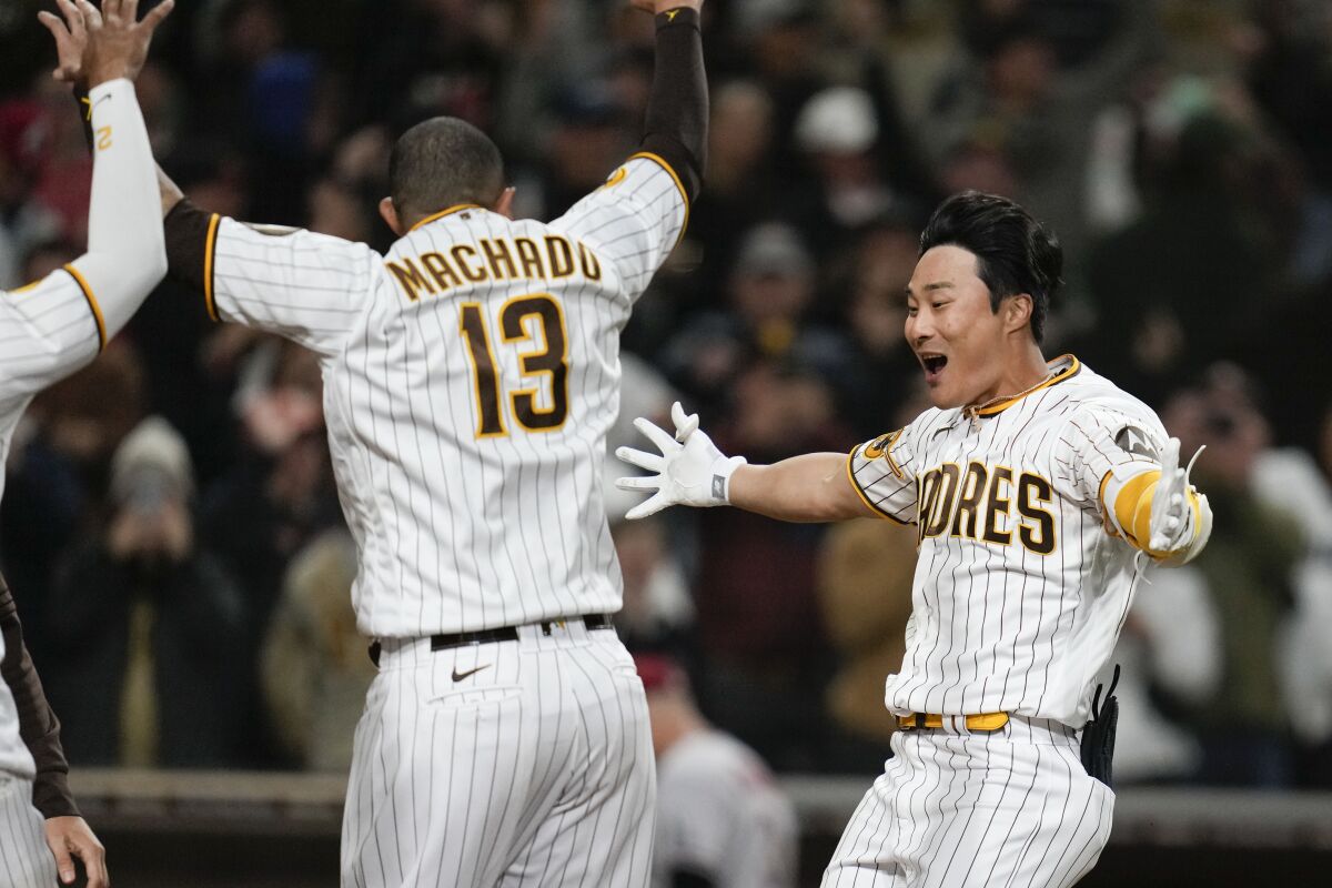 San Diego's Ha-Seong Kim, right, celebrates with teammates