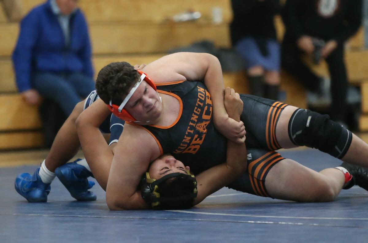 Huntington Beach's Tyson Finch wins his 195-pound match against Newport Harbor's Max Hernandez in the Wave League dual meet in Newport Beach on Wednesday.