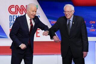 Democratic presidential candidates Joe Biden, left, and Bernie Sanders greet each other before Sunday's debate in Washington.