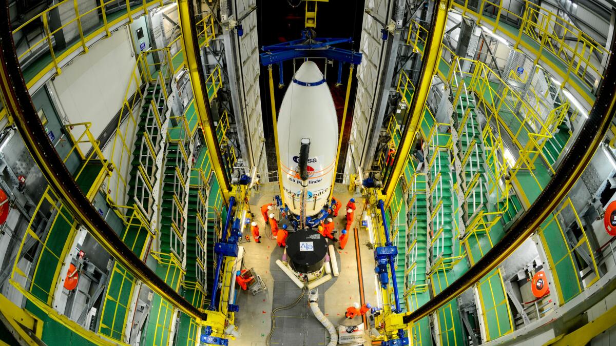 Workers hoist a module carrying the European Space Agency's LISA Pathfinder craft to the top of a rocket. Scientists in the U.K. are concerned about how "Brexit" will affect their work with the ESA and other European science groups.