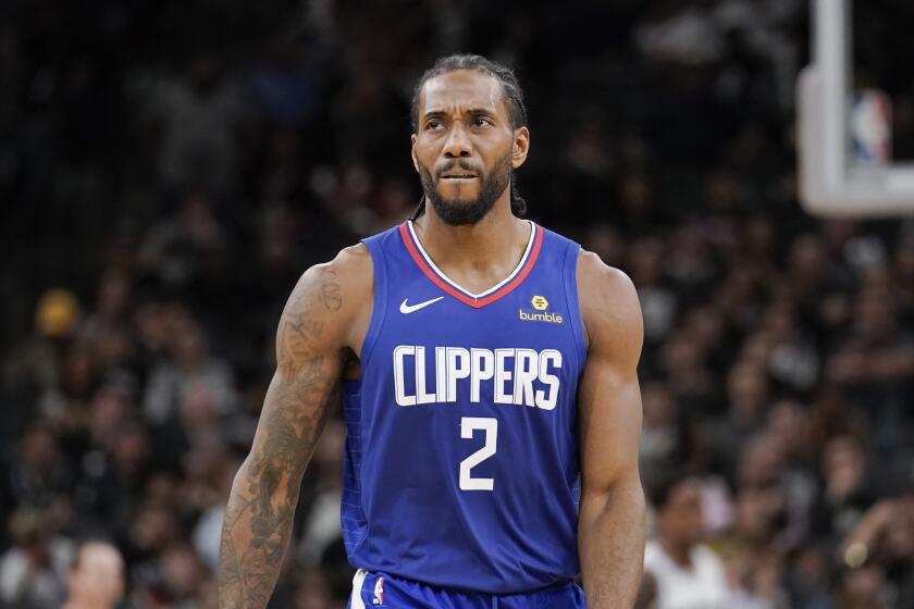 Los Angeles Clippers' Kawhi Leonard walks upcourt during the second half of an NBA basketball game against the San Antonio Spurs, Friday, Nov. 29, 2019, in San Antonio. San Antonio won 107-97. (AP Photo/Darren Abate)