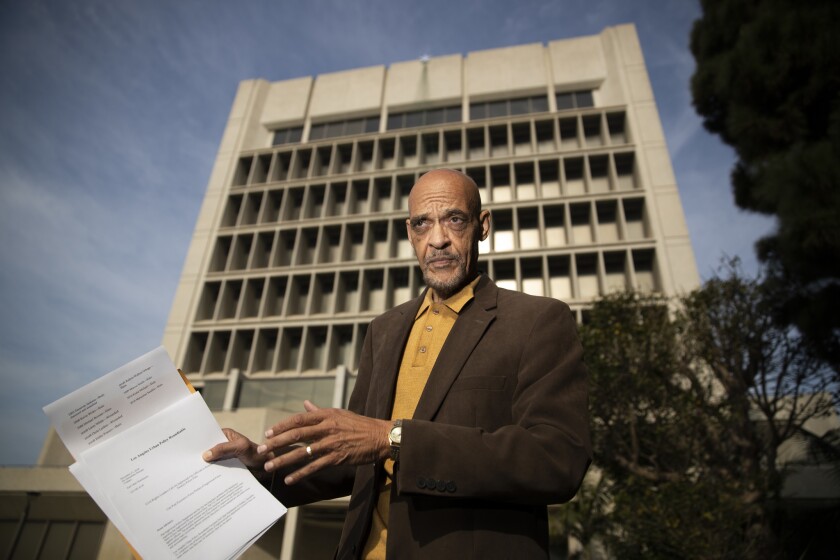 Earl Ofari Hutchinson holds a list of people who were killed or injured by Inglewood police.