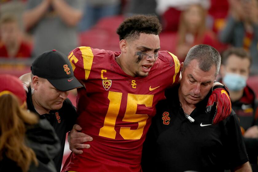 USC wide receiver Drake London is helped off the field after getting injured on a second-quarter touchdown Oct. 30, 2021.