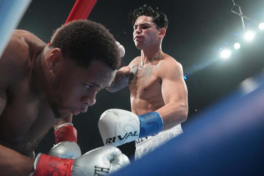 Ryan Garcia, right, punches Devin Haney during the first round of a super lightweight.