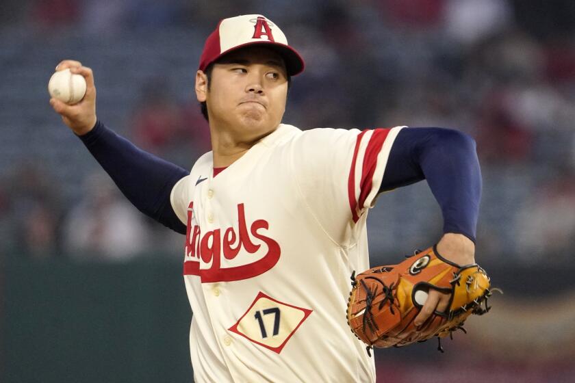 FILE - Los Angeles Angels starting pitcher Shohei Ohtani throws to the plate.
