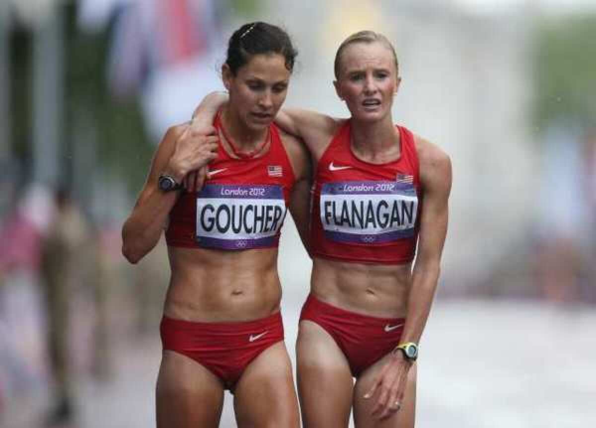 Kara Goucher and Shalane Flanagan of the United States at the finish line after completing the women's marathon.