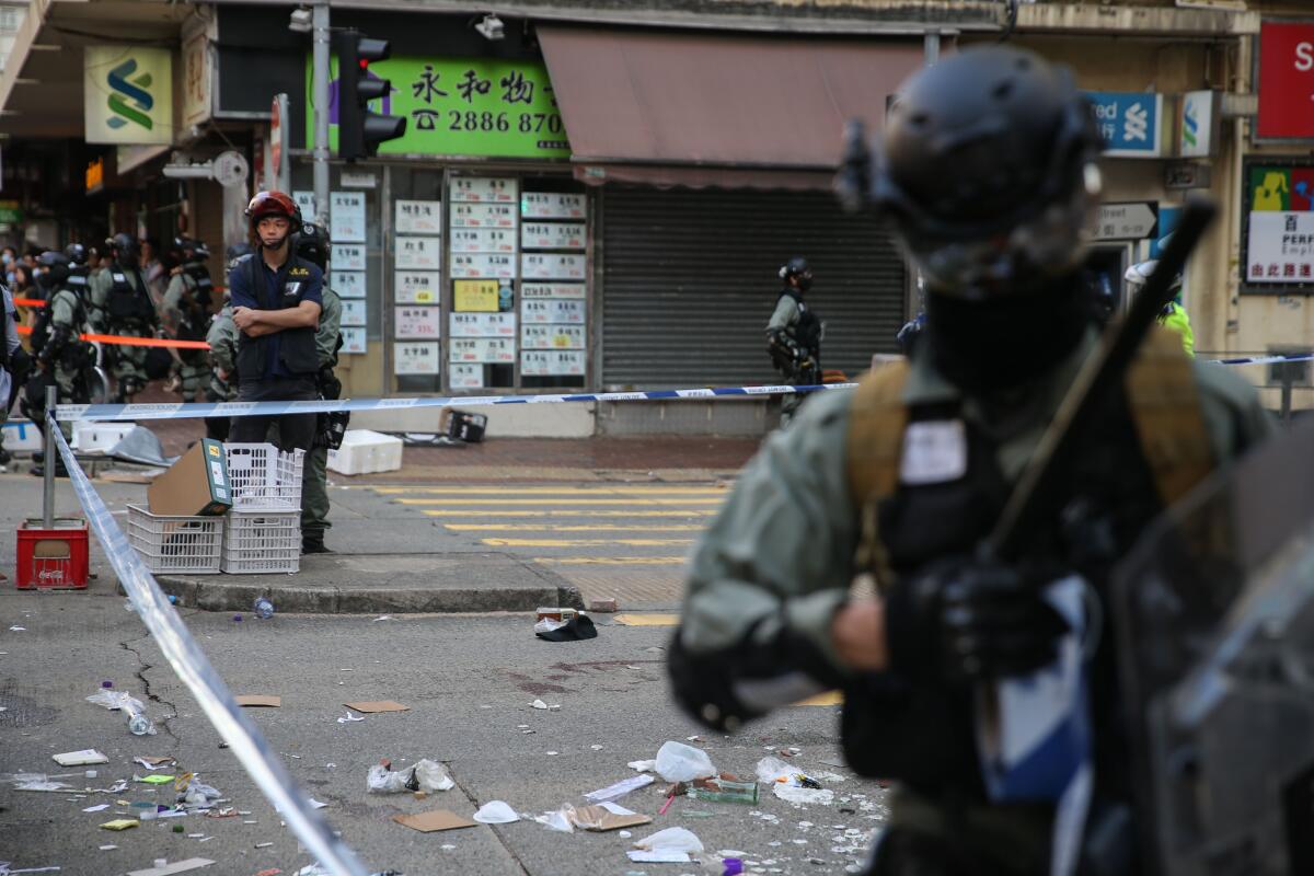 Police stand guard at an area in Hong Kong where a protester was shot by an officer.