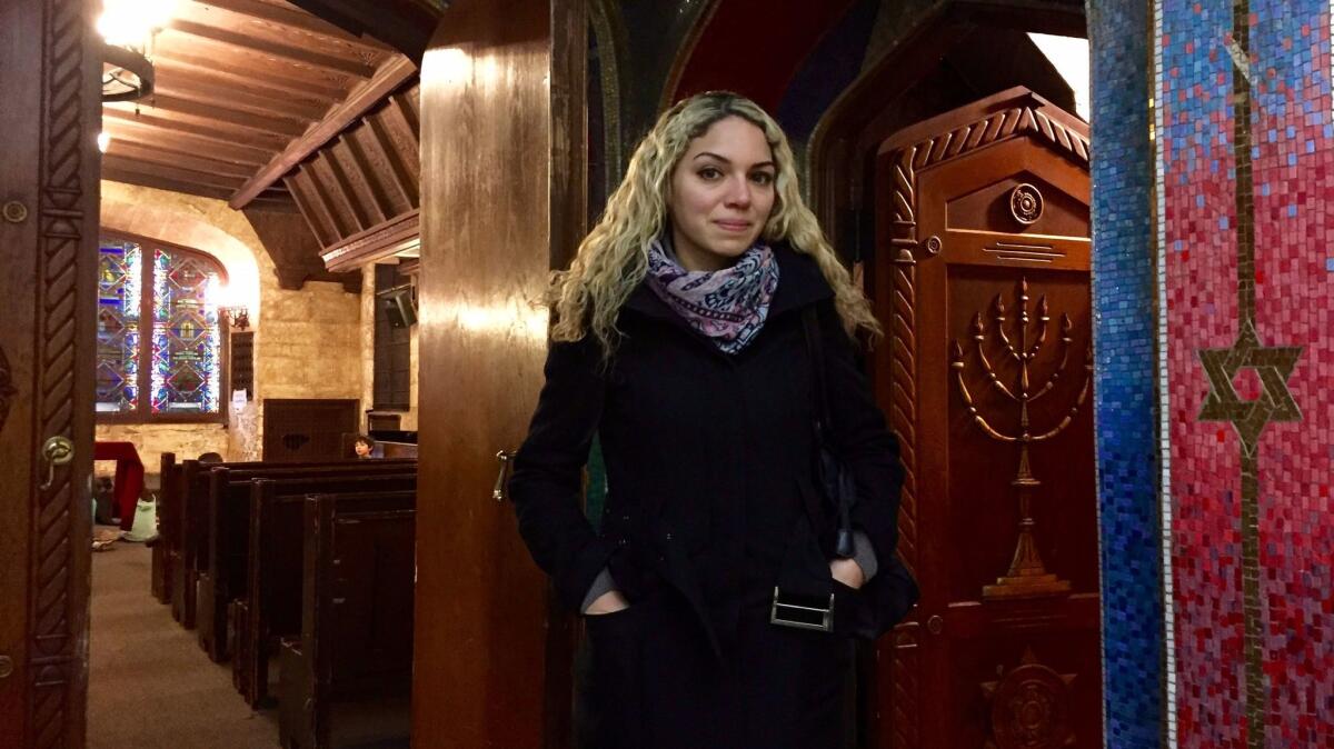 Ahed Festuk, a Syrian refugee, stands inside B'nai Jeshurun synagogue on New York's Upper West Side. She studies English in a free program housed in the synagogue's basement.