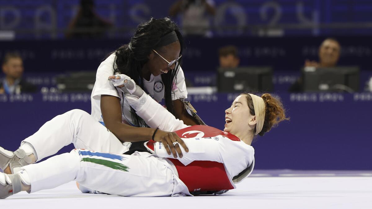 Zakia Khudadadi, of the Paralympic Refugee Team, celebrates her bronze medal in taekwondo during the Paralympics 