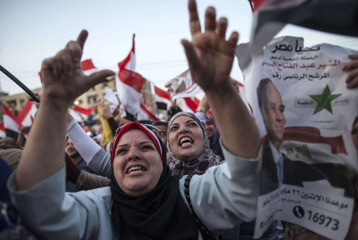 Egyptians celebrate in front of the presidential palace in Cairo on June 3 after ex-army chief Abdel Fattah Sisi won 96.9% of the vote.