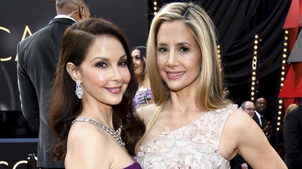 Ashley Judd, left, and Mira Sorvino arrive at the Oscars on Sunday at the Dolby Theatre.