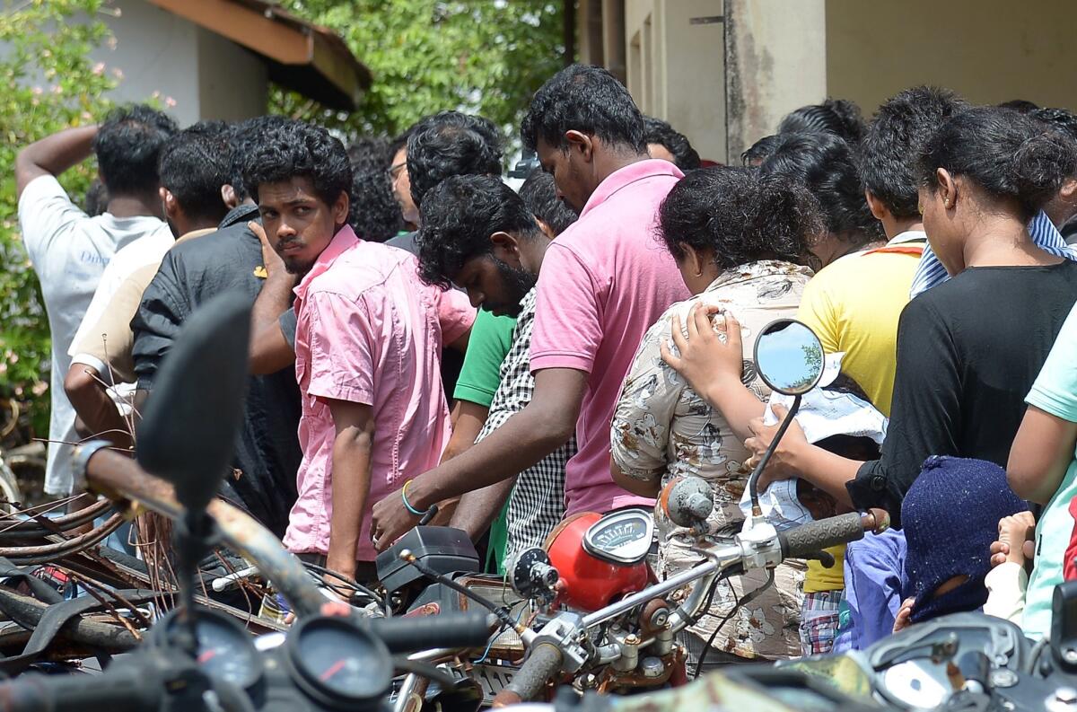 Sri Lankan asylum-seekers sent back by Australia enter a courthouse in Galle on July 8 to face charges of attempting to leave the country illegally.