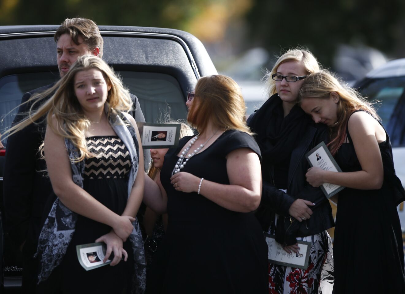 Mourners gather for the funeral of Damian Meins.