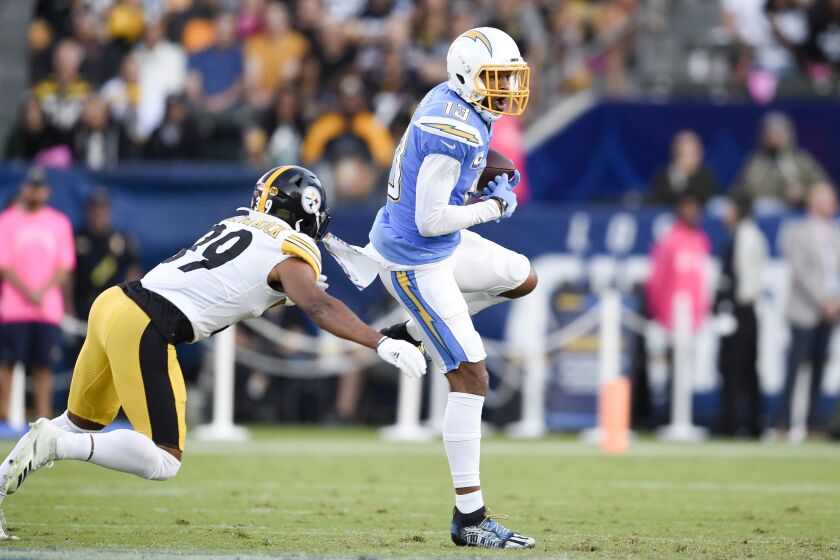 Los Angeles Chargers wide receiver Keenan Allen, right, makes a catch while under pressure from Pittsburgh Steelers free safety Minkah Fitzpatrick during the first half of an NFL football game, Sunday, Oct. 13, 2019, in Carson, Calif. (AP Photo/Kelvin Kuo)