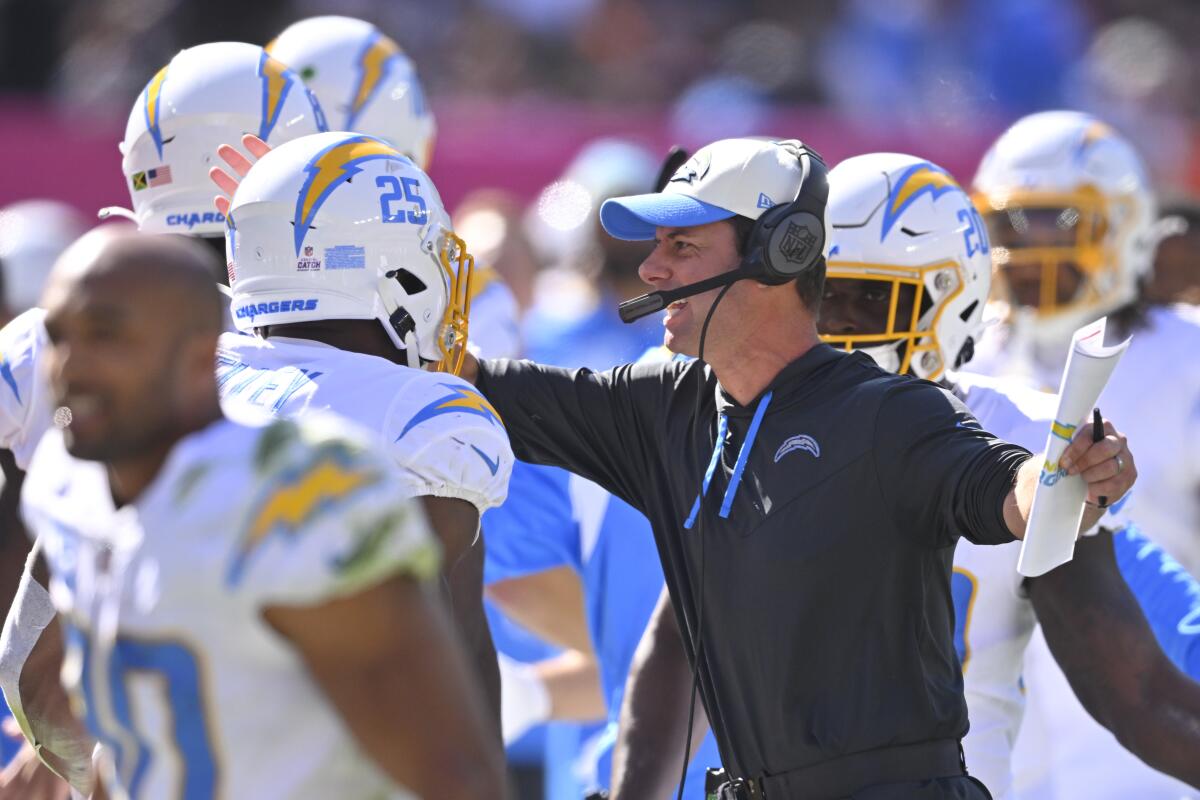 Chargers coach Brandon Staley celebrates with the team after the they scored a touchdown against the Cleveland Browns.