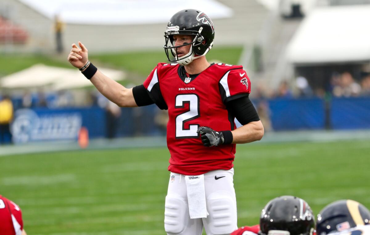 Falcons quarterback Matt Ryan directs a receiver during the first half of a game against the Rams on Dec. 11, 2016.