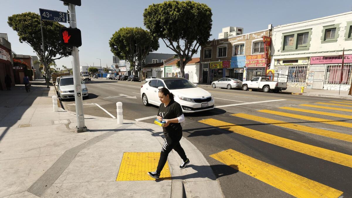 Vision Zero improvements in Historic South Central include new wheelechair ramps and new sidewalks at 43rd Street and Broadway that extend further into the street, reducing the distance that pedestrians must walk to reach the other side.