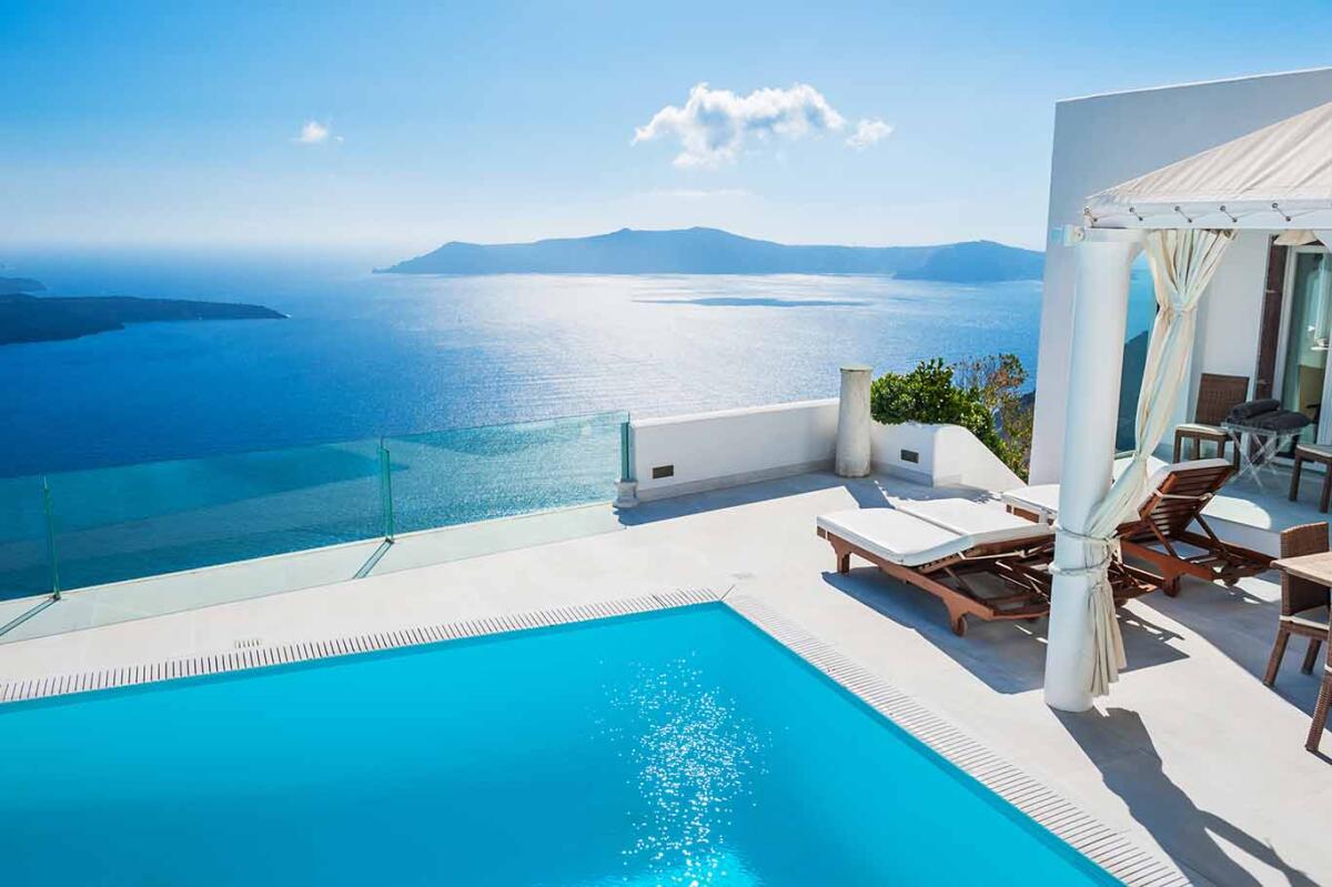 Swimming pool in luxury hotel with a sea view on Santorini island, Greece.