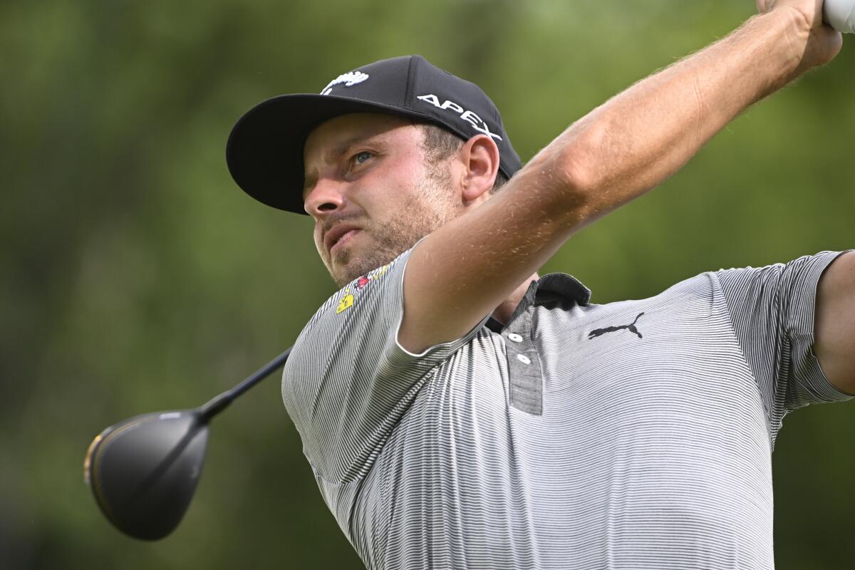 Adam Svensson, of Canada, tees off on the eighth hole during the first round of the Barbasol Championship golf tournament, Thursday, July 7, 2022, in Nicholasville, Ky. (AP Photo/John Amis)