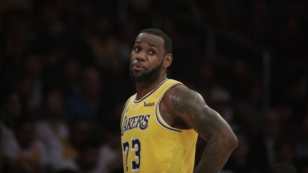 Lakers star LeBron James talks to a teammate during a game against the Washington Wizards on March 26.
