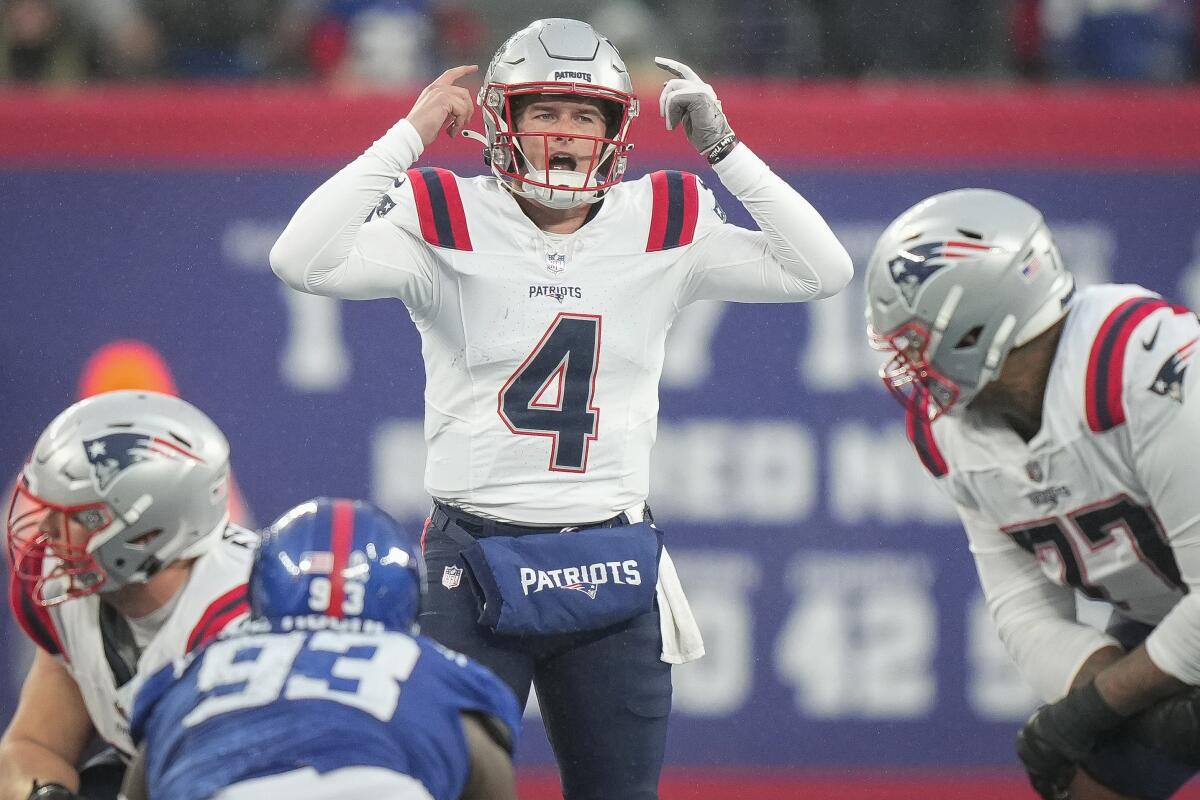  Patriots quarterback Bailey Zappe (4) calls signals during a Week 12 game against the Giants.