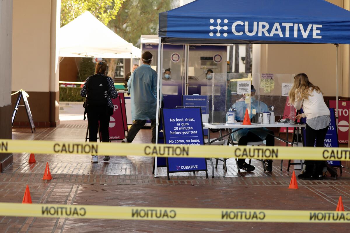 A Curative COVID-19 testing kiosk is set up outside Union Station in downtown Los Angeles.