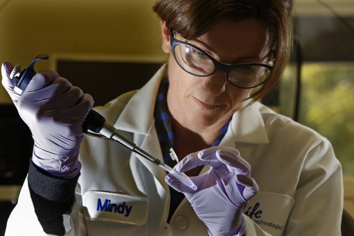 Molecular biologist Mindy Landes prepares a DNA sample for analysis in a Personal Genome Machine at Life Technologies in Carlsbad, Calif.