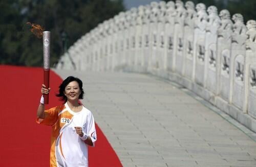 Zhou Ye, principal of Beijing Dongcheng Special Education School, takes part in the 2008 Paralympic torch relay in Beijing.
