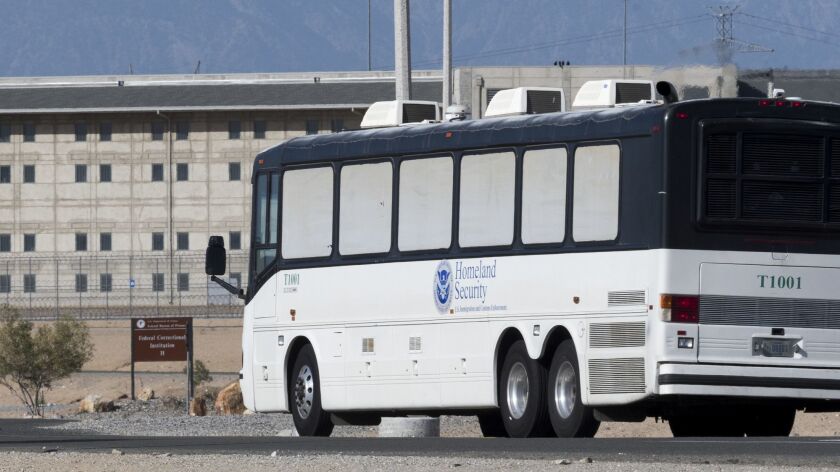 A Dept. Homeland Security bus enters the federal prison complex in Victorville in June, when nearly 1,000 immigration detainees were sent there.