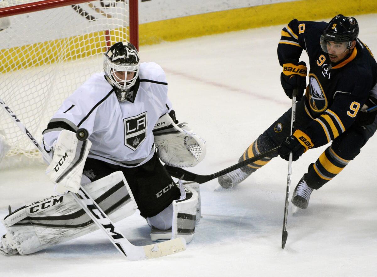 Kings goalie Jhonas Enroth (1) cannot stop the winning goal by Buffalo Sabres' Ryan O'Reilly (not shown) as Sabres forward Evander Kane (9) looks on during overtime.