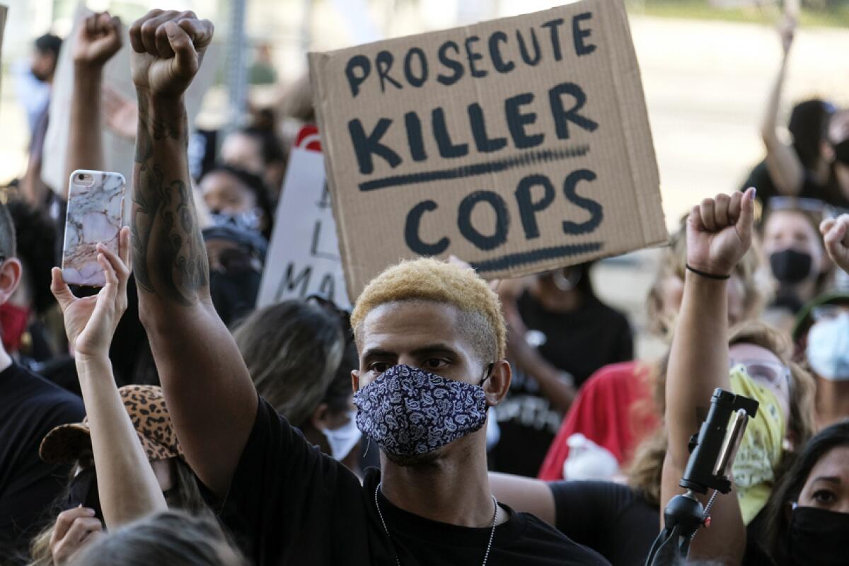 A demonstrator raises his fist during a protest May 27 in Minneapolis.