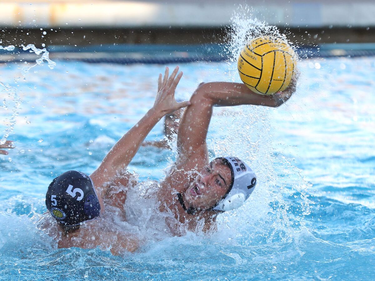 Ethan Spoon of Huntington Beach (9) pulls away from Owen Tift for a score during Thursday night's match.