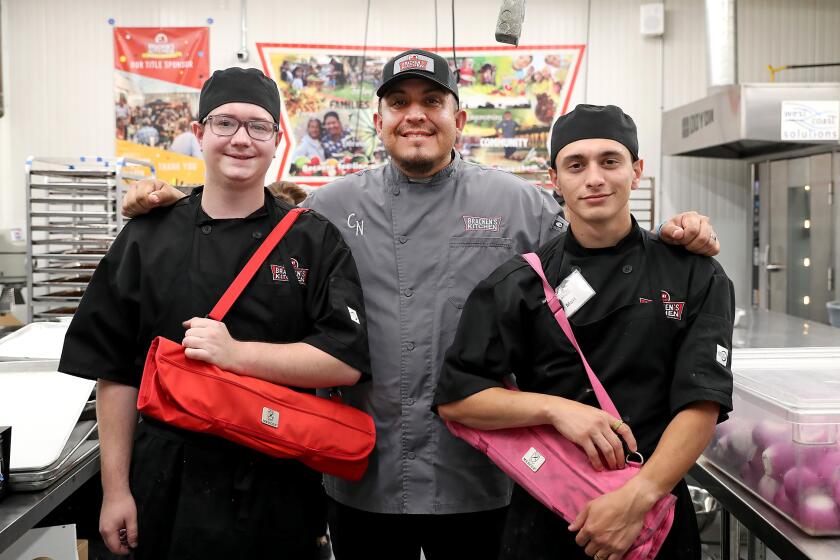 Students Lukas Romero, Chef Teacher Charlie Negrete, and student Matt Plonski, from left, at Bracken's Kitchen.