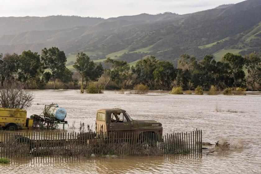TOPSHOT - A truck is submerged in floodwaters from the Salinas River near Chualar, California, on January 12, 2023. - A "relentless parade of cyclones" hitting California was expected to shift farther to the north, the US National Weather Service said Thursday, as the region continued to struggle with massive floods and landslides. At least 18 people are known to have died in the recent series of storms that have lashed the western US, bringing rainfall levels not seen in 150 years to some places. (Photo by Nic Coury / AFP) (Photo by NIC COURY/AFP via Getty Images)