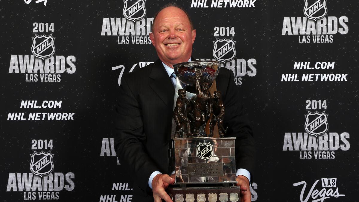 Ducks Executive Vice President and General Manager Bob Murray holds a trophy after being named the NHL's general manager of the year in 2014.