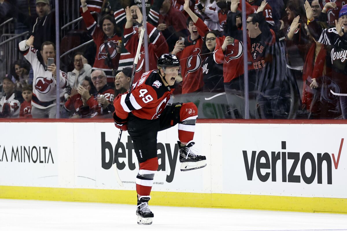 New Jersey Devils left wing Fabian Zetterlund reacts after scoring a goal against the Washington Capitals during the third period of an NHL hockey game Saturday, Nov. 26, 2022, in Newark, N.J. (AP Photo/Adam Hunger)