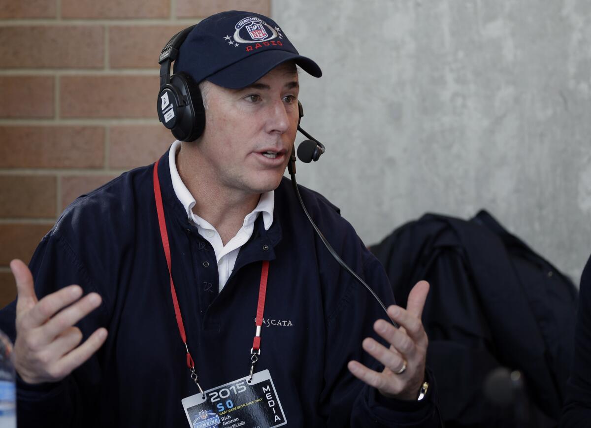 Rich Gannon conducts an interview at an NFL football scouting combine in Indianapolis.