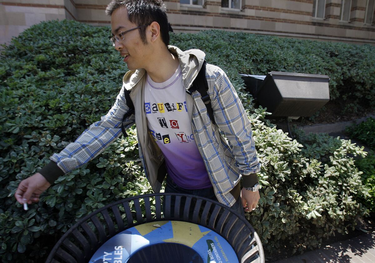 Hejia Yan, 23, throws away his cigarette butt on the campus of UCLA in 2013 on the first day of a tobacco ban on the campus. State lawmakers want to increase the tobacco tax.
