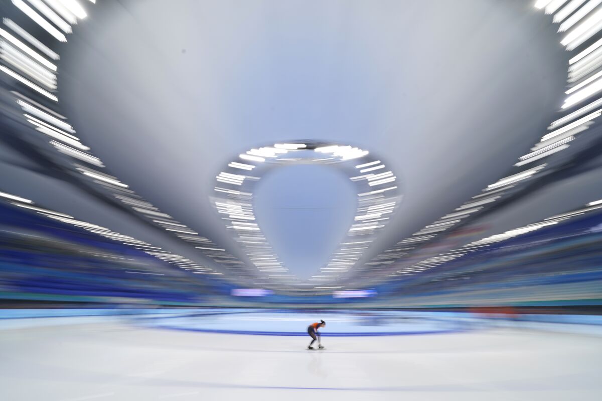 An athlete from the Netherlands skates during a speed skating practice session ahead of the 2022 Winter Olympics, Thursday, Feb. 3, 2022, in Beijing. (AP Photo/Ashley Landis)