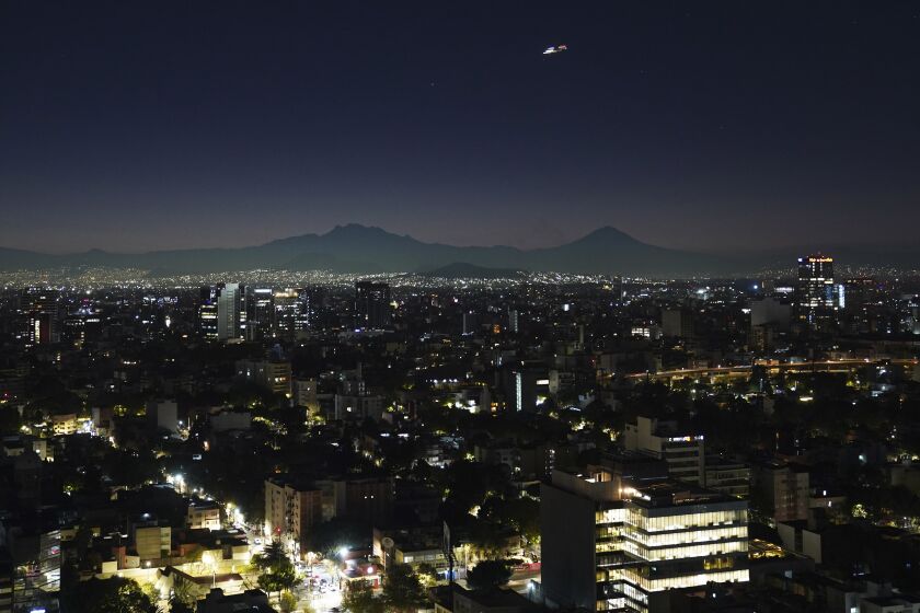 The sun begins to rise in Mexico City, Tuesday, Jan. 24, 2023. (AP Photo/Marco Ugarte)