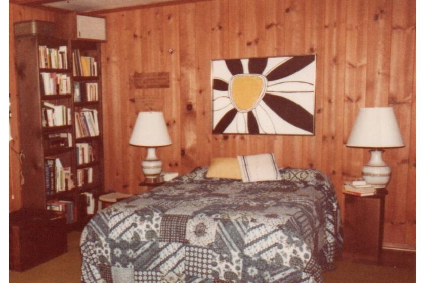 The wood paneling in Inga's bedroom before (top) and after painting.