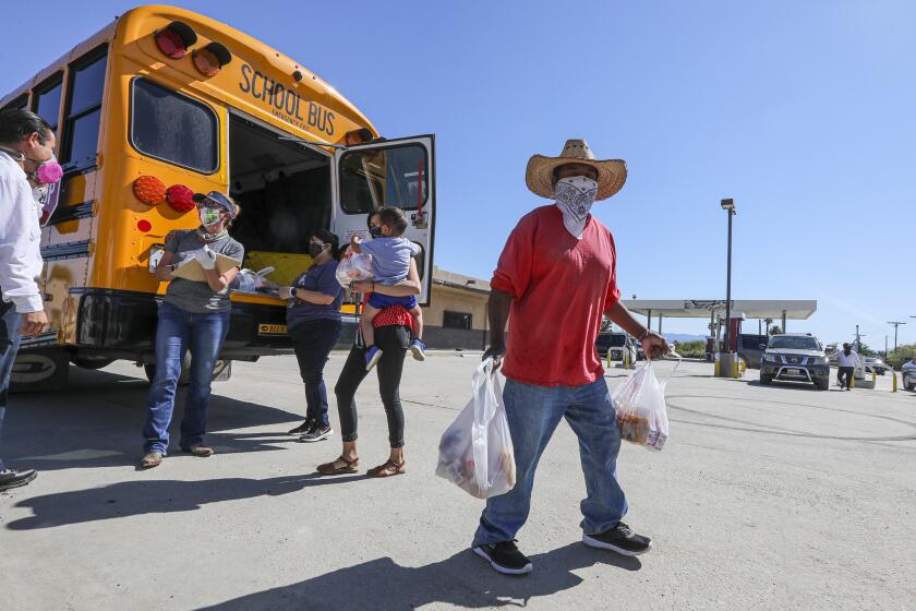 THERMAL, CA - APRIL 13: Coachella Valley Unified School District delivers meals in front of Oasis Mobile Home Park in Thermal. According district website students ages 1-18 may pick up their take-out meals each Monday and Wednesday. Two days' worth of meals are given on Mondays and three days' worth of meals are given on Wednesdays. (Irfan Khan / Los Angeles Times)