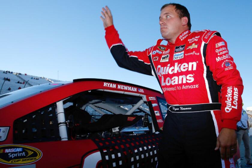 NASCAR driver Ryan Newman waves to fans after qualifying for the Sprint Cup Series Sylvania 300 at New Hampshire Motor Speedway on Friday.