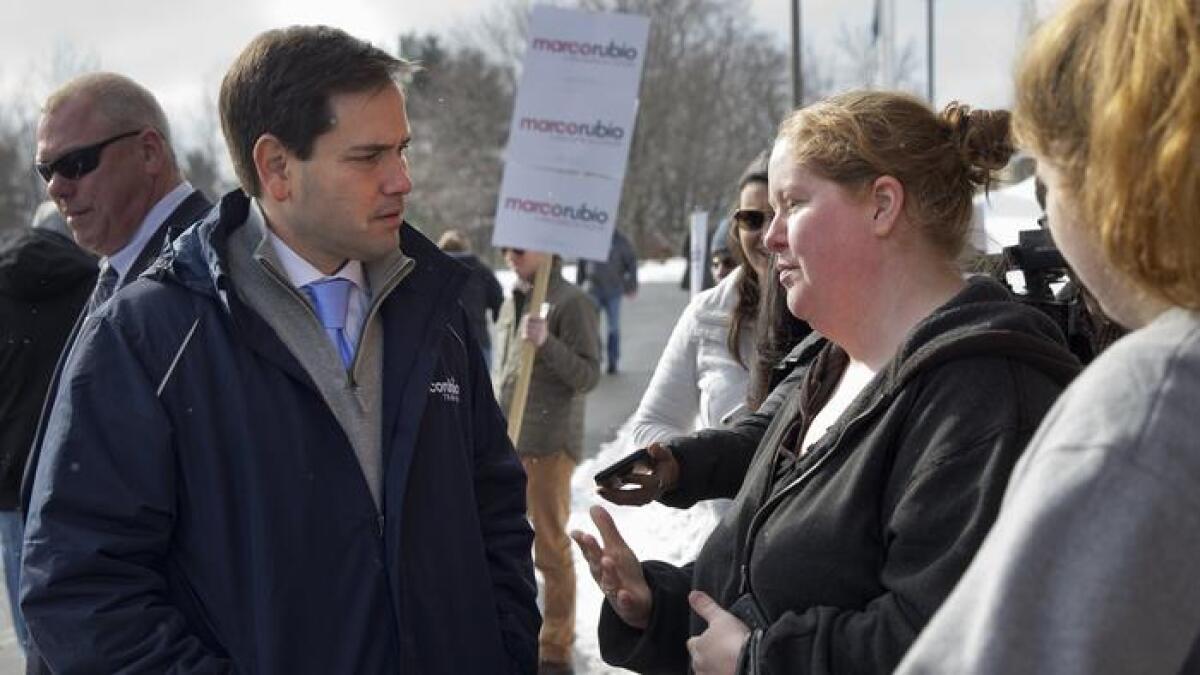 Republican presidential candidate Sen. Marco Rubio speaks with Stephanie Tespas outside Gilbert Hood Middle School in Derry, N.H.