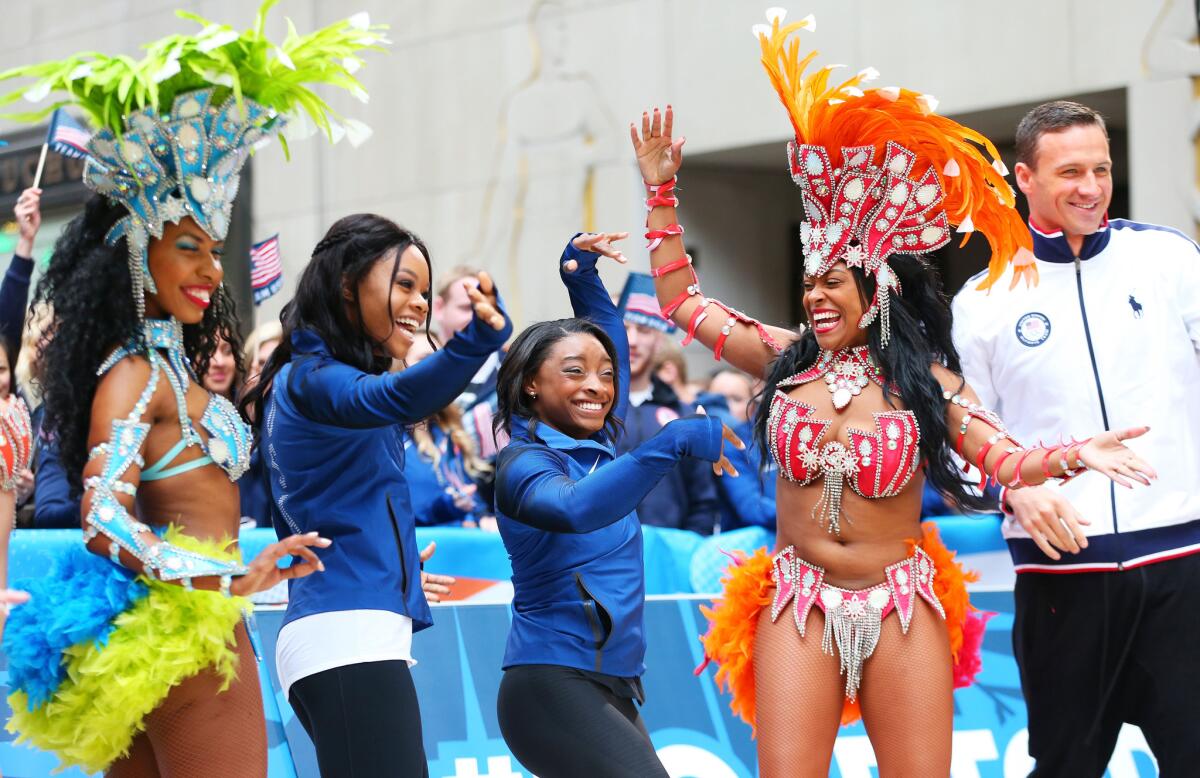 U.S. athletes Gabby Douglas, second from left, Simone Biles and Ryan Lochte visit NBC's "Today Show" set in New York City on Wednesday. The event marks 100 days until the opening ceremony of the Rio 2016 Olympic Games.
