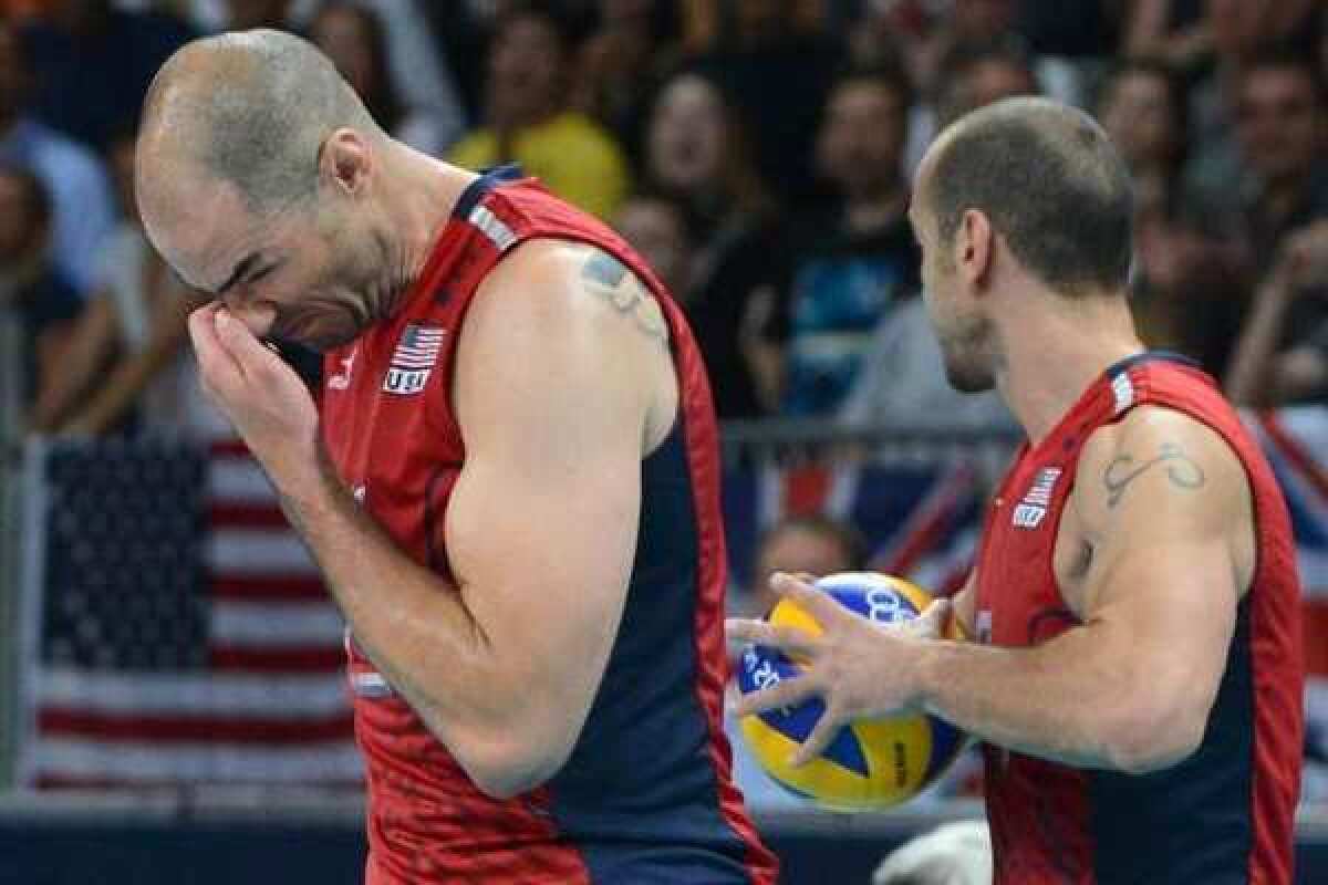 Clay Stanley, left, of the U.S. reacts during the men's quarterfinal volleyball match with Italy.
