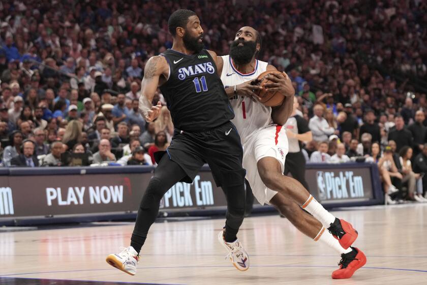 Los Angeles Clippers guard James Harden (1) drives against Dallas Mavericks guard Kyrie Irving.