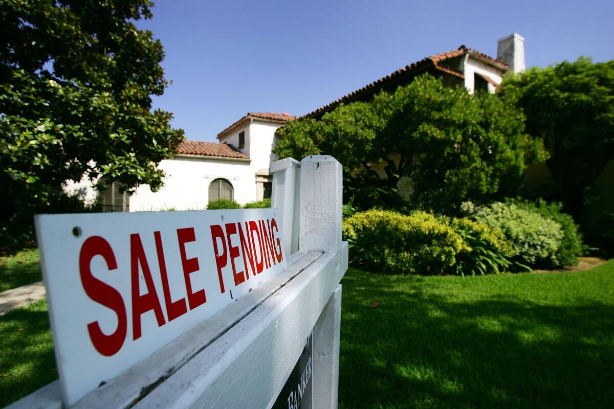 A "Sale Pending" sign is in front of a house
