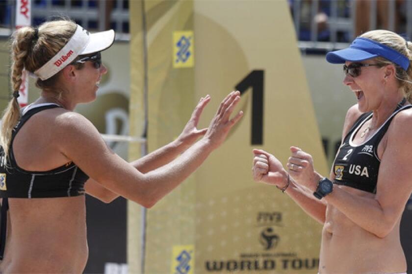 April Ross, left, and Kerri Walsh Jennings defeated Annett Davis and Morgan Miller, 19-21, 21-19, 15-13, to advance to the semifinals of the AVP Championships beach volleyball tournament in Huntington Beach on Saturday.