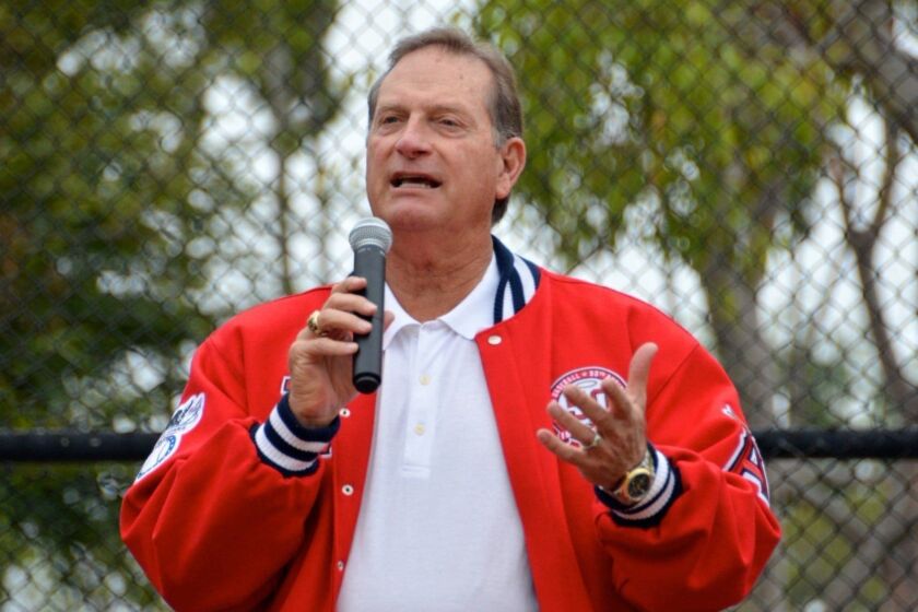 Guest speaker and former Angel baseball player, Doug DeCinces tells players to work on skill and have fun during the Newport Beach Baseball Assn. opening day ceremony held at Bonita Canyon Sports Park on Saturday.